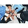 Closeup of happy business people with their heads together representing concept of ftiendship and teamwork isolated on white background
