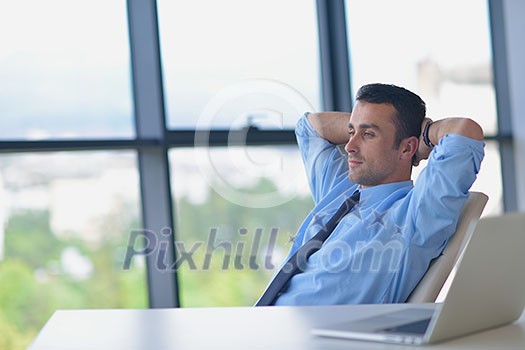 happy young business man work in modern office on computer happy young business man work in modern office on computer