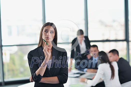 happy young business woman with her staff, people group in background at modern bright office indoors happy young business woman with her staff, people group in background at modern bright office indoors