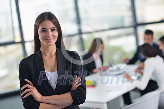 happy young business woman with her staff, people group in background at modern bright office indoors happy young business woman with her staff, people group in background at modern bright office indoors