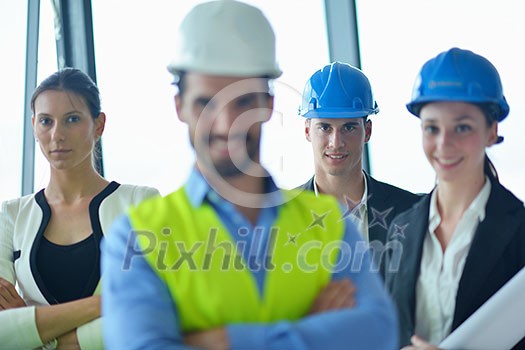 business people group on meeting and presentation in bright modern office with construction engineer architect and worker looking building model and blueprint planbleprint plans business people group on meeting and presentation in bright modern office with construction engineer architect and worker looking building model and blueprint planbleprint plans