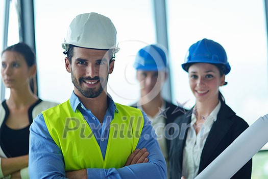 business people group on meeting and presentation in bright modern office with construction engineer architect and worker looking building model and blueprint planbleprint plans business people group on meeting and presentation in bright modern office with construction engineer architect and worker looking building model and blueprint planbleprint plans