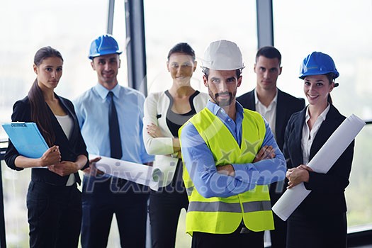 business people group on meeting and presentation in bright modern office with construction engineer architect and worker looking building model and blueprint planbleprint plans business people group on meeting and presentation in bright modern office with construction engineer architect and worker looking building model and blueprint planbleprint plans