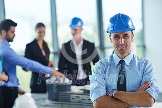 business people group on meeting and presentation  in bright modern office with construction engineer architect and worker looking building model and blueprint planbleprint plans