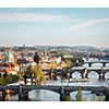 Travel Prague concept background - elevated view of bridges over Vltava river from Letna Park with tilt shift toy effect shallow depth of field. Prague, Czech Republic