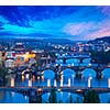 Travel Prague concept background - elevated view of bridges over Vltava river from Letna Park. Prague, Czech Republic in twilight