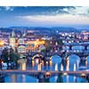 Travel Prague concept background - elevated view of bridges over Vltava river from Letna Park with tilt shift toy effect shallow depth of field. Prague, Czech Republic in twilight