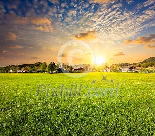 Idyllic rural scene of countryside meadow field on sunset, Germany