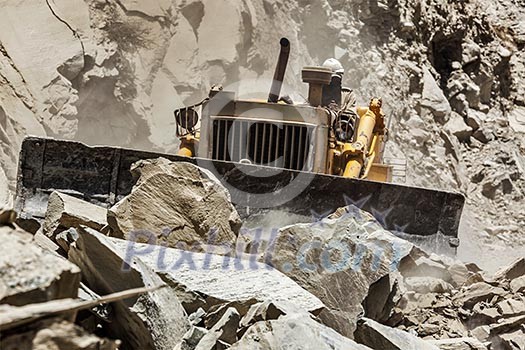 Bulldozer doing mountain road construction in Himalayas. Himachal Pradesh, India Bulldozer doing mountain road construction in Himalayas. Himachal Pradesh, India