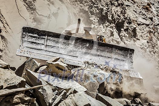 Bulldozer doing mountain road construction in Himalayas. Himachal Pradesh, India