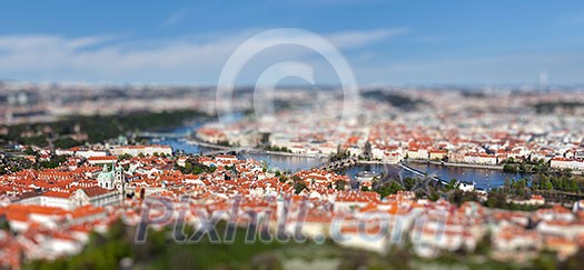 Aerial view of Charles Bridge over Vltava river and Old city from Petrin hill Observation Tower with tilt shift toy effect shallow depth of field. Prague, Czech Republic