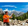 Hiker trekker studying map route on trek in Himalayas mountains. Himachal Pradesh,India
