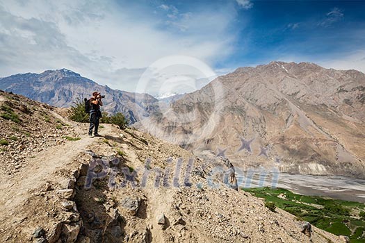Photographer taking photos in Himalayas mountains. Spiti valley, Himachal Pradesh, India Photographer taking photos in Himalayas mountains. Spiti valley, Himachal Pradesh, India