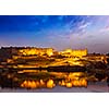 Amer Fort Amber Fort illuminated at night - one of principal attractions in Jaipur, Rajastan, India refelcting in Maota lake in twilight