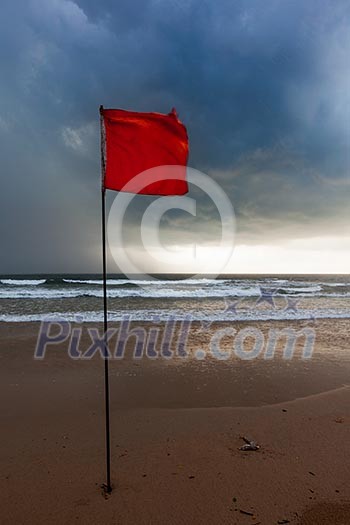 Severe storm warning flags on beach. Baga, Goa, India