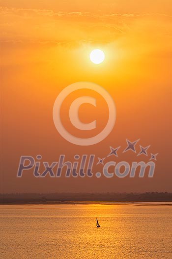 Yacht boats silhouettes in lake on sunset