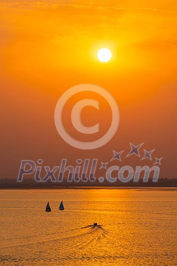 Yacht boats silhouettes in lake on sunset, India Yacht boats silhouettes in lake on sunset, India