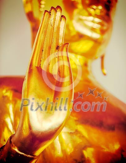 Vintage retro effect filtered hipster style travel image of Buddha golden statue blessing hand, Wat Pho, Bangkok,  Thailand. Low point of view