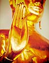 Vintage retro effect filtered hipster style travel image of Buddha golden statue blessing hand, Wat Pho, Bangkok,  Thailand. Low point of view