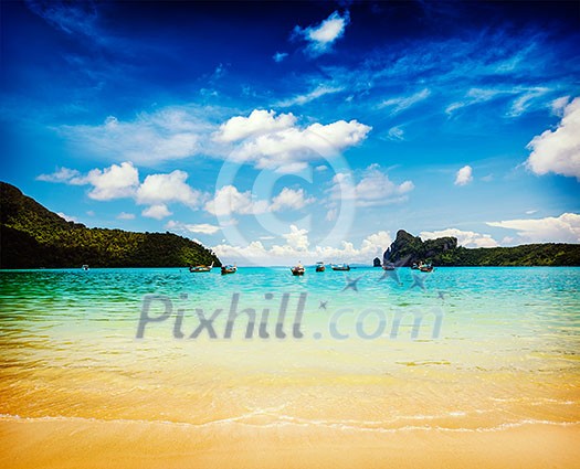 Vintage retro effect filtered hipster style travel image of long tail boats in bay. Phi Phi Island, Krabi, Thailand