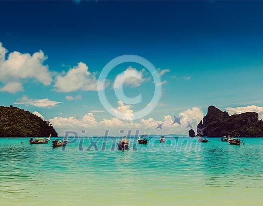 Vintage retro effect filtered hipster style travel image of long tail boats in bay. Phi Phi Island, Krabi, Thailand Vintage retro effect filtered hipster style travel image of long tail boats in bay. Phi Phi Island, Krabi, Thailand