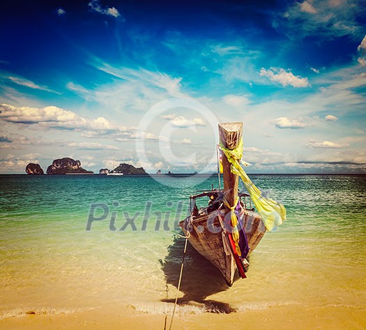 Vintage retro effect filtered hipster style travel image of long tail boat on tropical beach, Krabi, Thailand