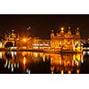 Sikh sacred site gurdwara Sri Harmandir Sahib also known as The Golden Temple also Darbar Sahib illuminated at night. Amritsar, Punjab state, India