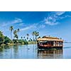 Travel tourism Kerala background - houseboat on Kerala backwaters. Kerala, India