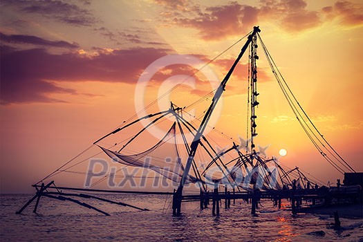 Vintage retro hipster style travel image of Kochi chinese fishnets on sunset. Fort Kochin, Kochi, Kerala, India Vintage retro hipster style travel image of Kochi chinese fishnets on sunset. Fort Kochin, Kochi, Kerala, India