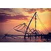 Vintage retro hipster style travel image of Kochi chinese fishnets on sunset. Fort Kochin, Kochi, Kerala, India