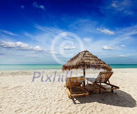 Two beach lounge chairs under tent on beach. Sihanoukville, Cambodia