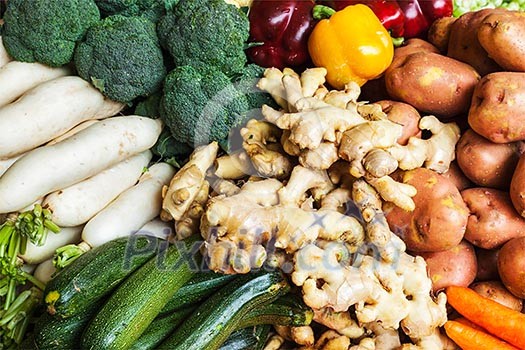 Vegetables in Asian market close up - zucchini, Capsicum bell peppers, potatoes, ginger, broccoli  cabbage,  daikon white radish