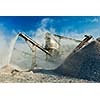 Industrial background - crusher rock stone crushing machine at open pit mining and processing plant for crushed stone, sand and gravel