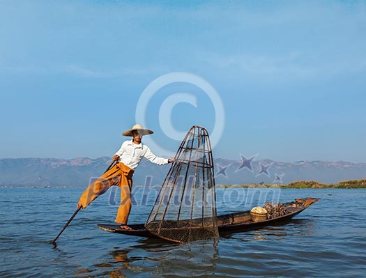 Myanmar travel attraction landmark - Traditional Burmese fisherman at Inle lake, Myanmar famous for their distinctive one legged rowing style Myanmar travel attraction landmark - Traditional Burmese fisherman at Inle lake, Myanmar famous for their distinctive one legged rowing style