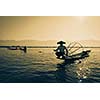 Myanmar travel attraction landmark - Traditional Burmese fisherman at Inle lake, Myanmar famous for their distinctive one legged rowing style