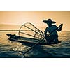 Myanmar travel attraction landmark - Traditional Burmese fisherman at Inle lake, Myanmar famous for their distinctive one legged rowing style