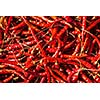 Red spicy chili peppers at asian market close up texture background