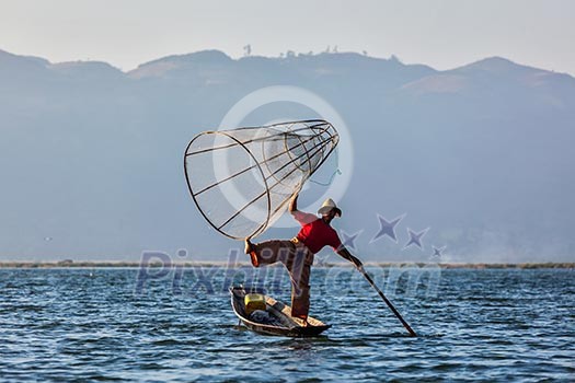 Myanmar travel attraction landmark - Traditional Burmese fisherman at Inle lake, Myanmar famous for their distinctive one legged rowing style Myanmar travel attraction landmark - Traditional Burmese fisherman at Inle lake, Myanmar famous for their distinctive one legged rowing style