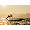 Myanmar travel attraction landmark - Traditional Burmese fisherman at Inle lake, Myanmar famous for their distinctive one legged rowing style