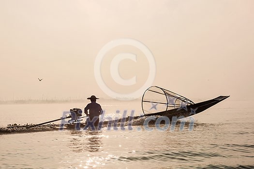 Myanmar travel attraction landmark - Traditional Burmese fisherman with fishing net at Inle lake in speeding motor boat Myanmar travel attraction landmark - Traditional Burmese fisherman with fishing net at Inle lake in speeding motor boat