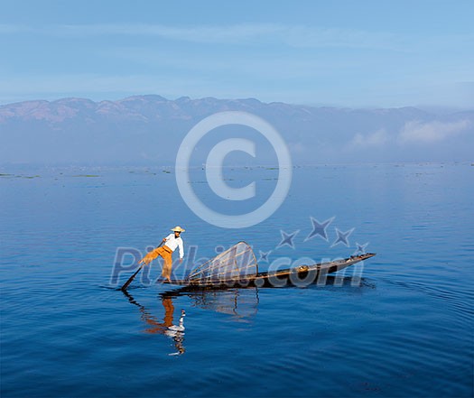 Myanmar travel attraction landmark - Traditional Burmese fisherman at Inle lake, Myanmar famous for their distinctive one legged rowing style Myanmar travel attraction landmark - Traditional Burmese fisherman at Inle lake, Myanmar famous for their distinctive one legged rowing style