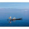 Myanmar travel attraction landmark - Traditional Burmese fisherman at Inle lake, Myanmar famous for their distinctive one legged rowing style