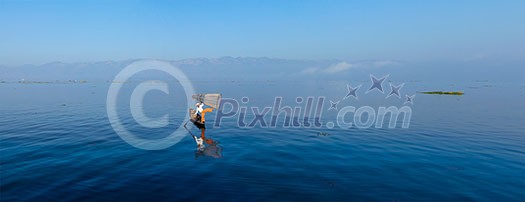 Panorama of traditional Burmese fisherman balancing with fishing net at Inle lake, Myanmar famous for their distinctive one legged rowing style Panorama of traditional Burmese fisherman balancing with fishing net at Inle lake, Myanmar famous for their distinctive one legged rowing style