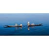 Panorama of traditional Burmese fishermen with fishing net at Inle lake in Myanmar famous for their distinctive one legged rowing style