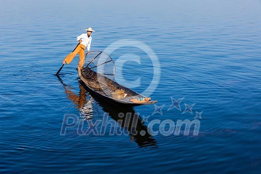 Myanmar travel attraction landmark - Traditional Burmese fisherman at Inle lake, Myanmar famous for their distinctive one legged rowing style Myanmar travel attraction landmark - Traditional Burmese fisherman at Inle lake, Myanmar famous for their distinctive one legged rowing style