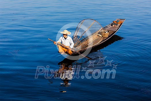 Myanmar travel attraction landmark - Traditional Burmese fisherman at Inle lake, Myanmar famous for their distinctive one legged rowing style Myanmar travel attraction landmark - Traditional Burmese fisherman at Inle lake, Myanmar famous for their distinctive one legged rowing style