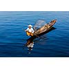 Myanmar travel attraction landmark - Traditional Burmese fisherman at Inle lake, Myanmar famous for their distinctive one legged rowing style