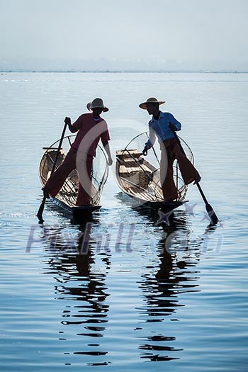 Myanmar travel attraction landmark - Traditional Burmese fisherman at Inle lake, Myanmar famous for their distinctive one legged rowing style