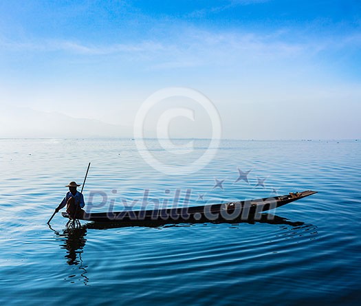 Myanmar travel attraction landmark - Traditional Burmese fisherman at Inle lake, Myanmar famous for their distinctive one legged rowing style Myanmar travel attraction landmark - Traditional Burmese fisherman at Inle lake, Myanmar famous for their distinctive one legged rowing style
