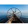 Myanmar travel attraction landmark - Traditional Burmese fisherman with fishing net at Inle lake in Myanmar famous for their distinctive one legged rowing style, view from boat